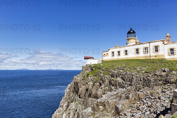 Lighthouse with foghorn on cliff