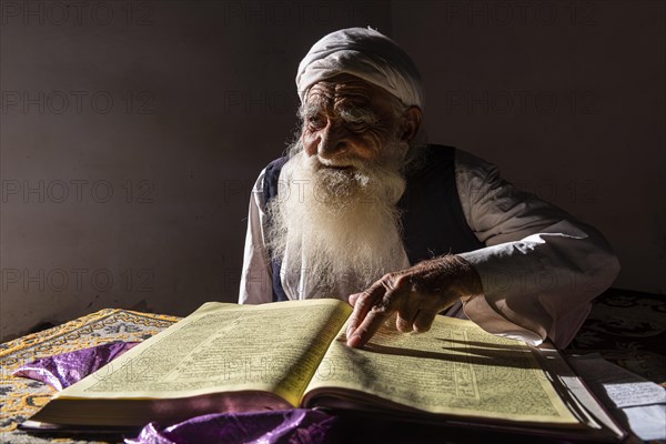 Sufi priest studying the holy Quran in the Shrine of Mawlana Abdur Rahman Jami