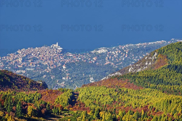 Lake Garda with colourful mountain forest and the small town of Malcesine