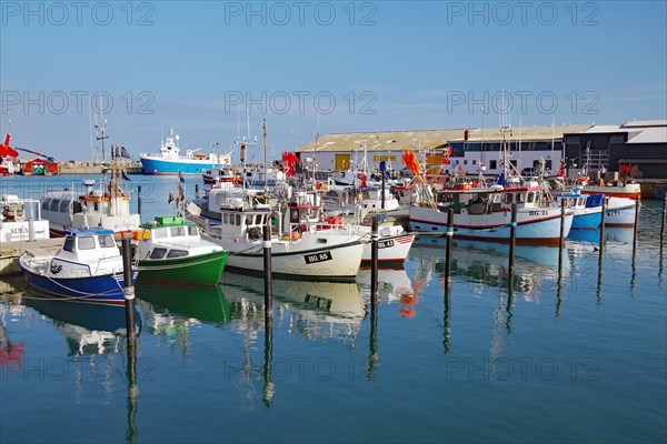 Small fishing boats reflected in the water