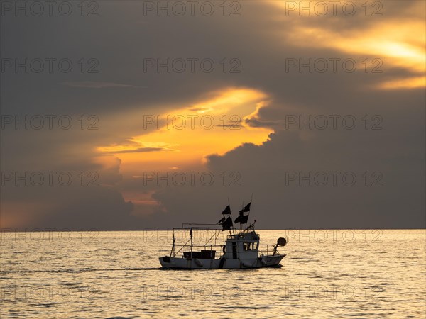Fishing boat in front of dark clouds