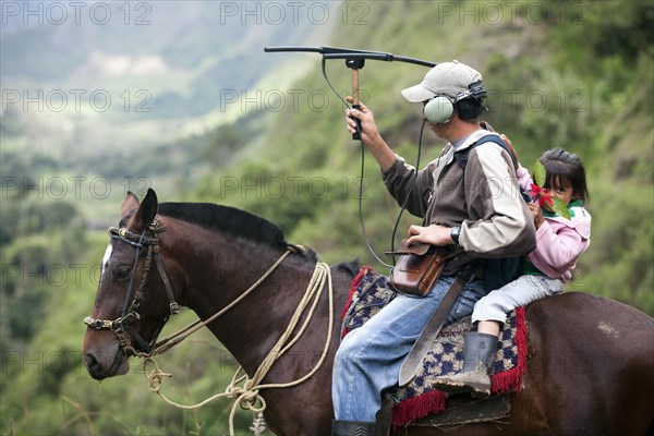 Biologist tracking spectacled bear with radio antenna