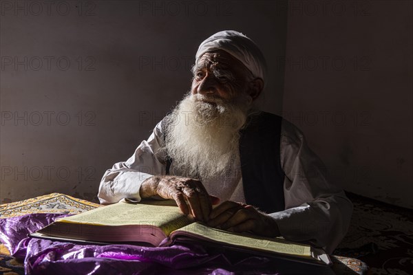 Sufi priest studying the holy Quran in the Shrine of Mawlana Abdur Rahman Jami