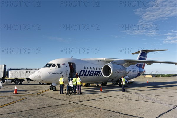 Passengers disembark Antonov An-158 regional jet