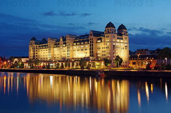 Large building at the harbour reflected in the water