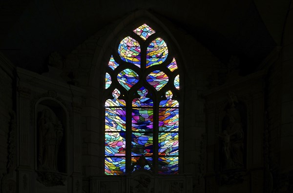 Stained glass window in the chancel of La Chapelle de Notre Dame de Bonne Nouvelle et sa fontaine