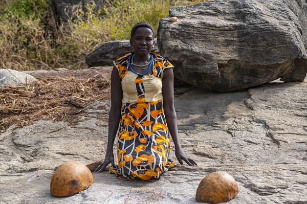 Young girls grinding Sorghum on a rock