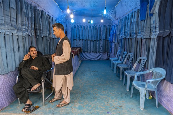 Men in their Burqa shop in Herat