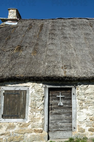 Wooden cross on a door of farm