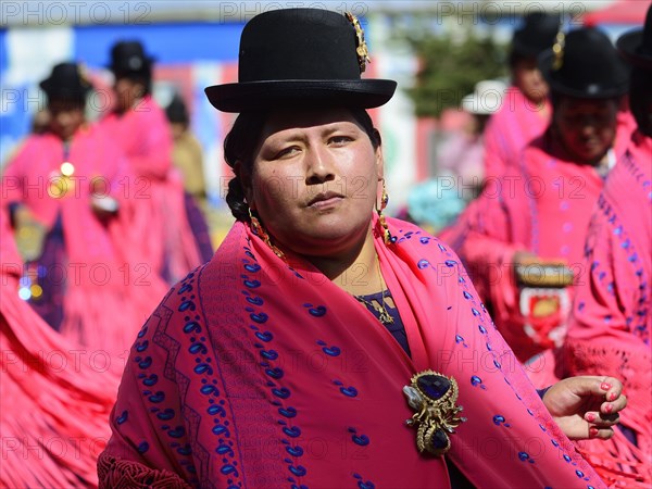 Indigenous woman of a dance group in traditional costumes during a parade