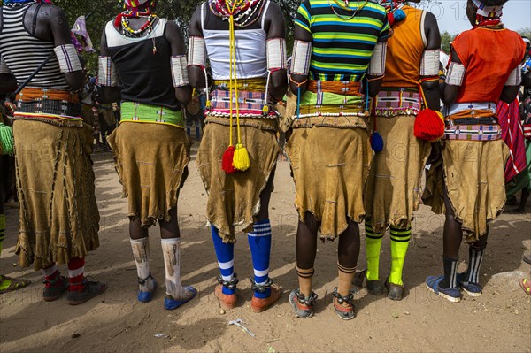 Close up from the cow skin skirs of traditional dressed young girls practising local dances