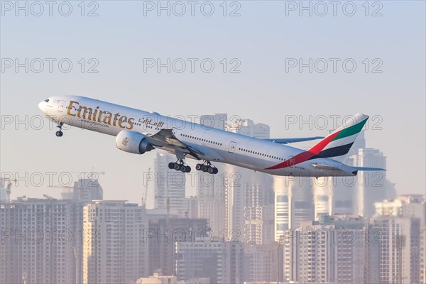An Emirates Boeing 777-300ER aircraft with registration A6-EBK takes off from Dubai Airport