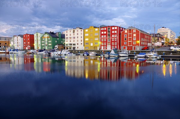 Illuminated houses reflected in a body of water