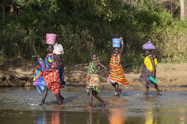 Women walking through a river bed