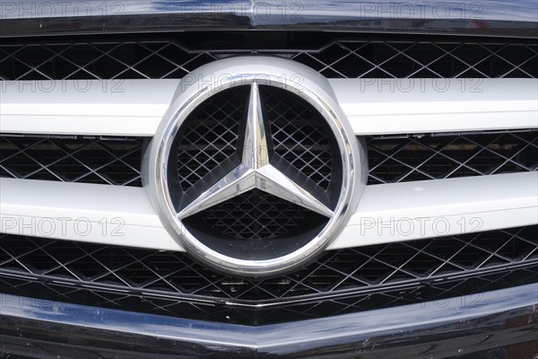 Mercedes star on the radiator grille of the vehicle