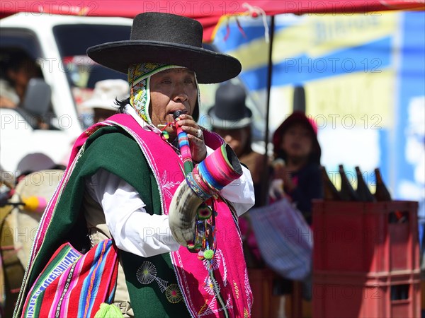 Indigenous musician in traditional costume