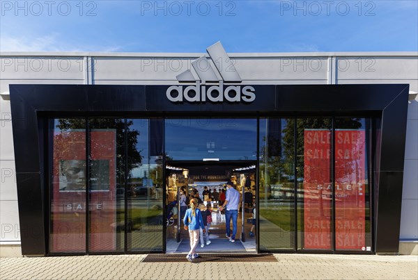 Customers enter Adidas Brand Store