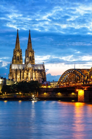 Cologne Cathedral Skyline and Hohenzollern Bridge with Rhine River in Germany at night in Cologne