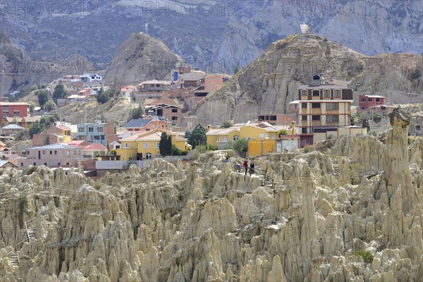 Residential houses behind the bizarre rock formations in Valle de la Luna