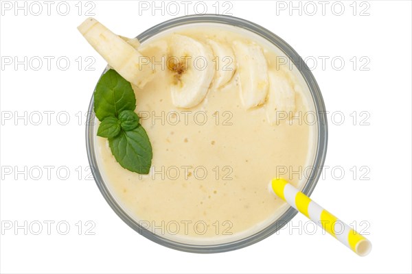 Banana smoothie fruit juice drink juice in glass from above exempted isolated