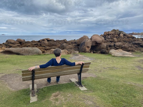 Elderly woman sitting on bench