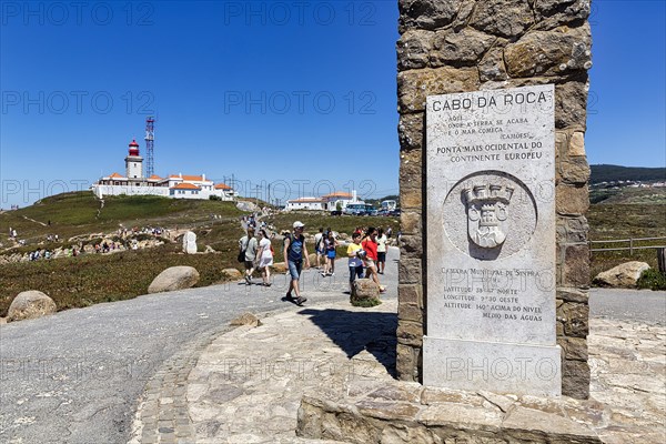 Tourists at the monument with information board