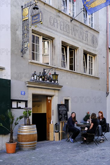 Young people sitting in front of a pub