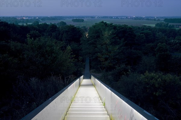 View from the illuminated sky staircase into the landscape at dawn