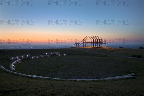 Illuminated hall house at sunrise on the North Germany slagheap