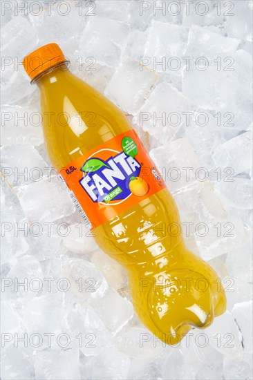 Fanta Orange lemonade soft drink beverage in a plastic bottle on ice cube ice cubes in Germany