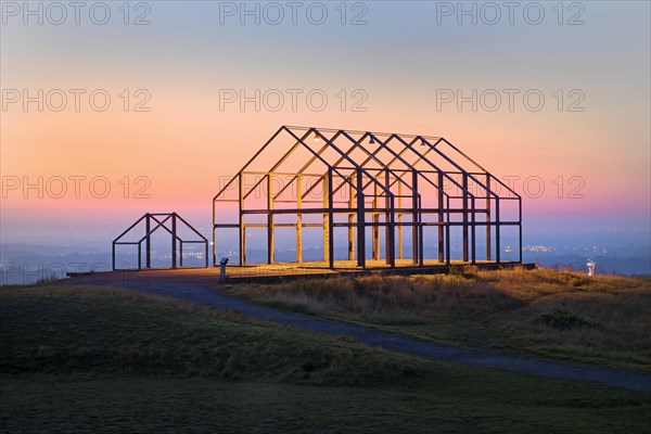 Illuminated hall house at sunrise on the North Germany slagheap