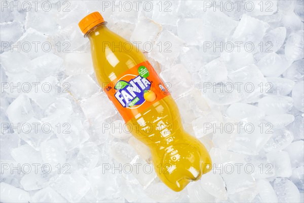 Fanta Orange lemonade soft drink beverage in a plastic bottle on ice cube ice cubes in Germany