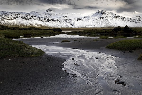 Mountain panorama with snow at low tide