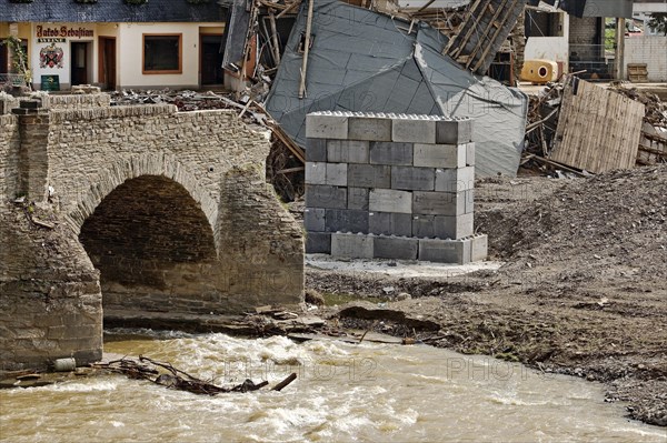 Destroyed house at the broken Nepomuk bridge with the river Ahr