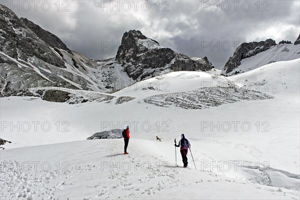 Winter hike at the snow-covered mountain lake Lac de la Case