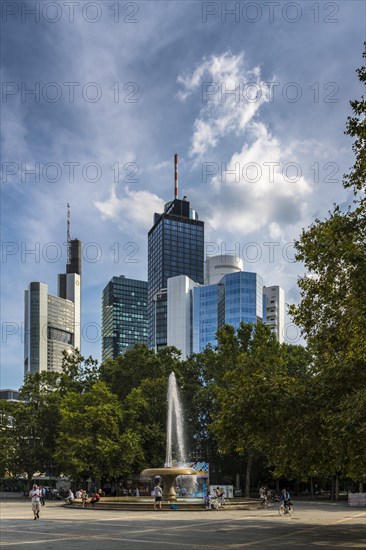 Lucae Fountain on Opernplatz in front of the skyline of Frankfurt am Main with the high-rise buildings Buerohaus an der Alten Oper