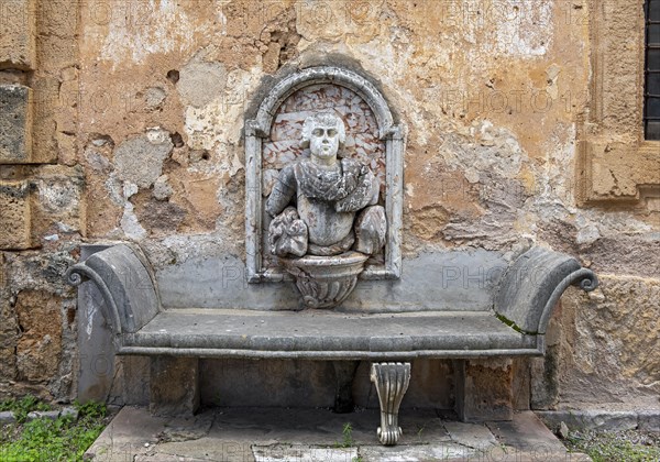 Stone bench with wall relief
