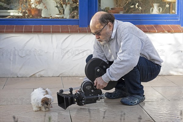 Animal photographer films Bolonka Zwetna puppy with 16mm camera