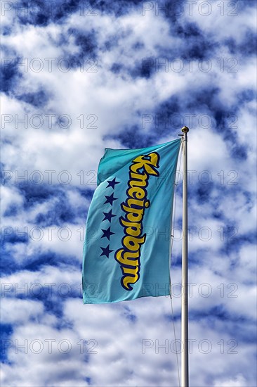 Kneippbyn advertising flag against a slightly cloudy sky