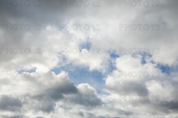 Stratocumulus clouds and blue sky windows form spectacular cloud formation in the sky during Foehn storm