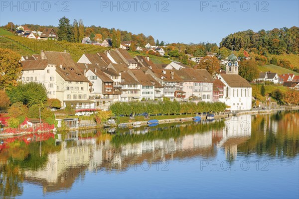 View from the Rhine bridge over the Rhine towards the old town of Eglisau with reflection on the river water