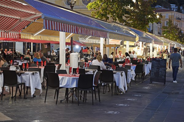 Evening hustle and bustle with restaurants and market stalls on the Cours Saleya