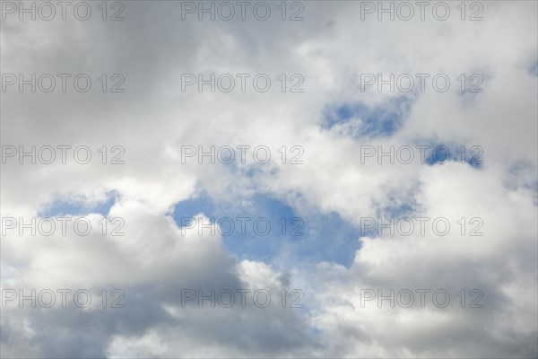 Stratocumulus clouds and blue sky windows form spectacular cloud formation in the sky during Foehn storm