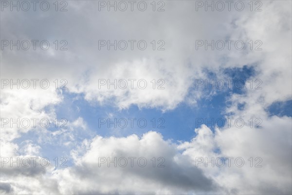 Stratocumulus clouds and blue sky windows form spectacular cloud formation in the sky during Foehn storm