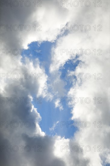 Stratocumulus clouds and blue sky windows form spectacular cloud formation in the sky during Foehn storm