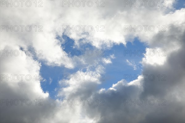 Stratocumulus clouds and blue sky windows form spectacular cloud formation in the sky during Foehn storm