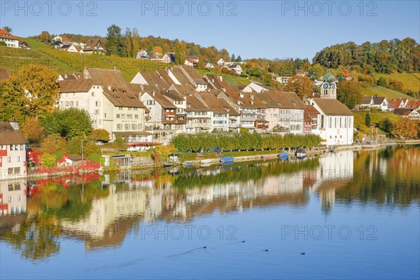 View from the Rhine bridge over the Rhine towards the old town of Eglisau with reflection on the river water