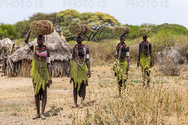 Girls with collected reeds on their heads on their way home