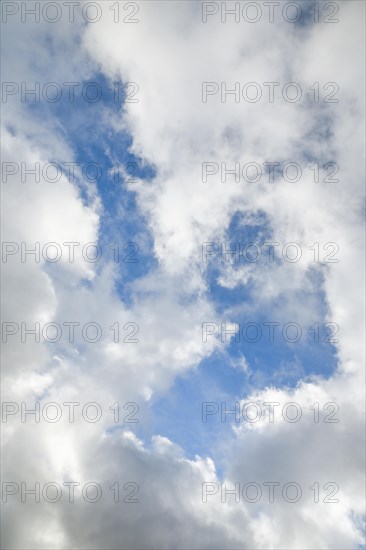 Stratocumulus clouds and blue sky windows form spectacular cloud formation in the sky during Foehn storm