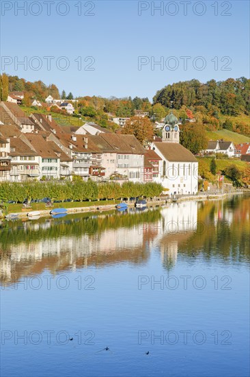 View from the Rhine bridge over the Rhine towards the old town of Eglisau with reflection on the river water